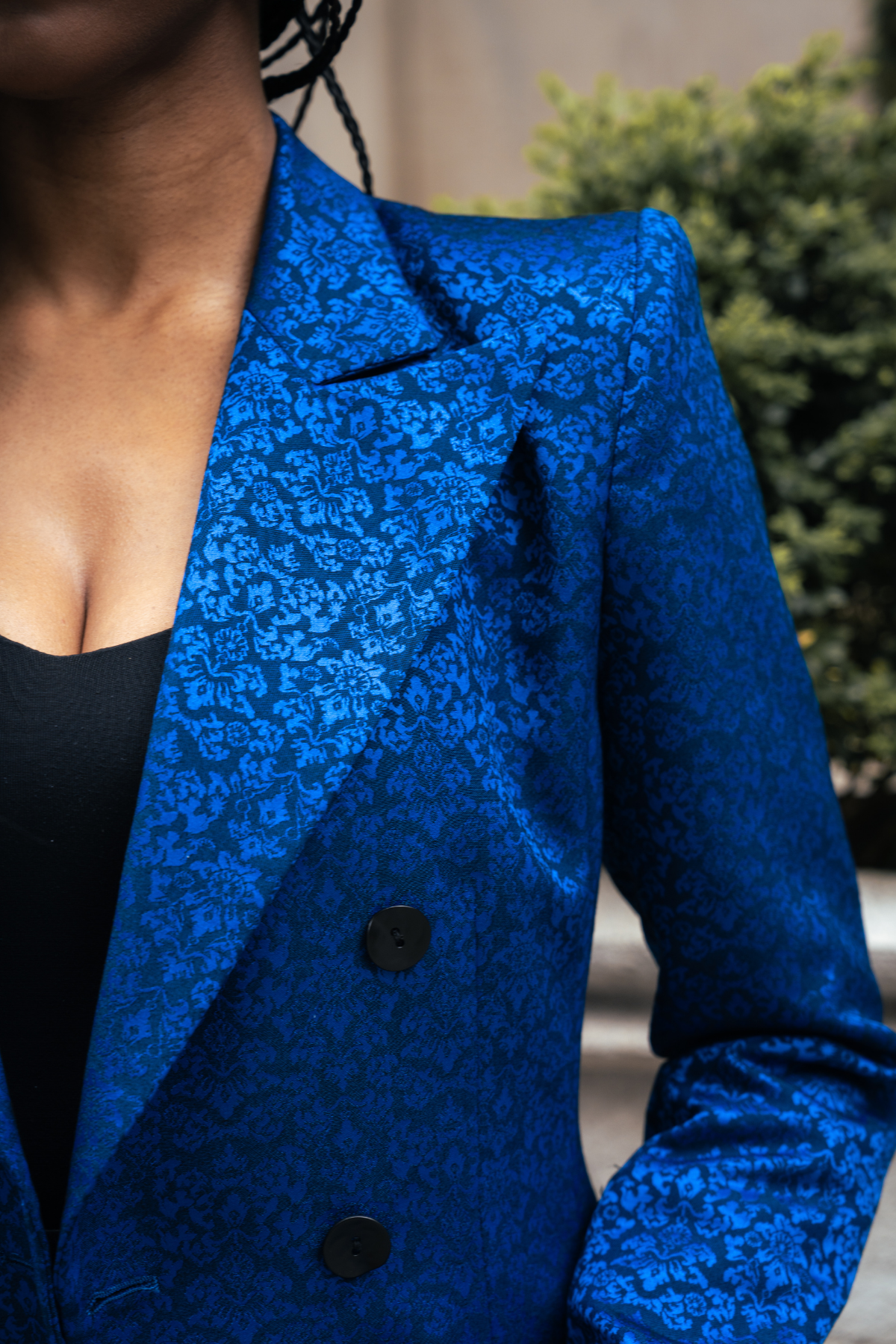 Blue textured blazer worn by a woman with a blurred background