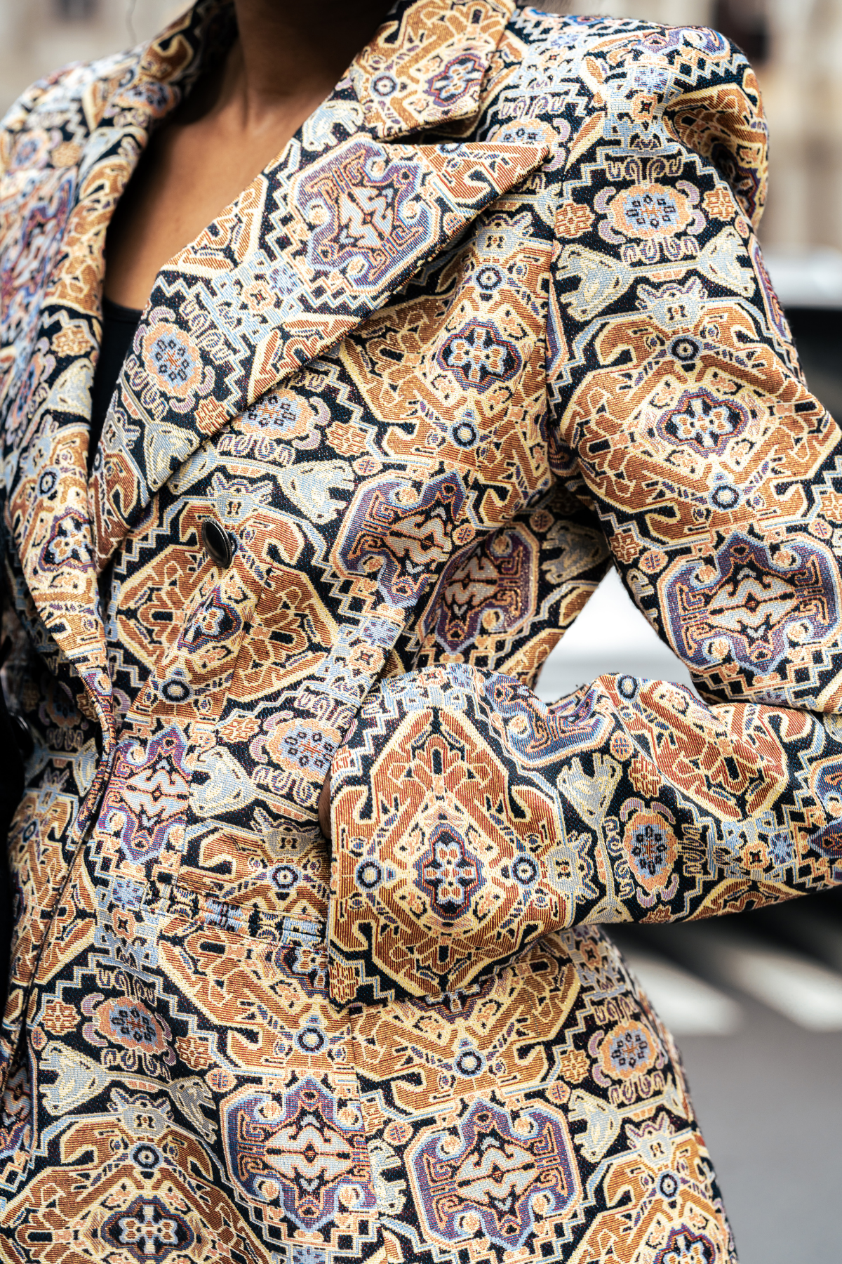 Close-up of a patterned coat with intricate designs.
